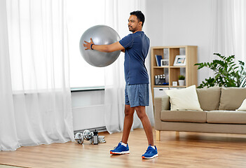 Image showing indian man exercising with fitness ball at home