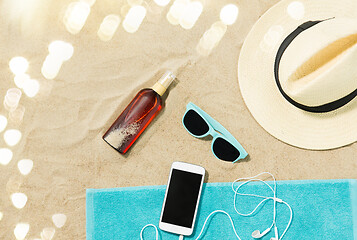 Image showing smartphone, hat, flip flops and shades on beach