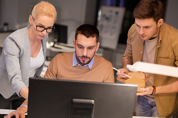 Image showing business team with computer working late at office