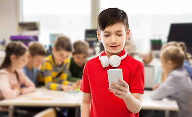 Image showing boy in red t-shirt with headphones and smartphone