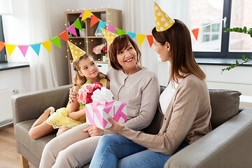 Image showing mother with gift greeting grandmother on birthday