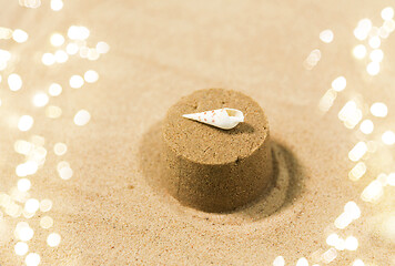 Image showing sand shape made by mold with shell on summer beach