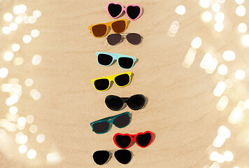 Image showing different sunglasses on beach sand