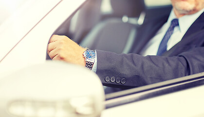 Image showing senior businessman hands driving car