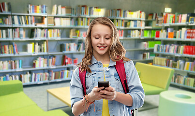 Image showing teenage student girl with smartphone at library