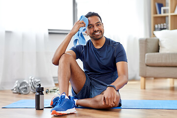 Image showing tired indian man with towel after training at home