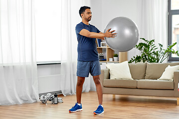 Image showing indian man exercising with fitness ball at home