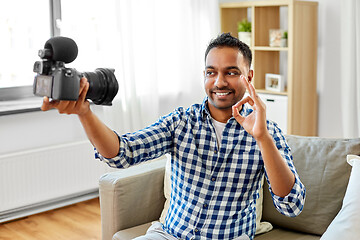 Image showing male video blogger with camera blogging at home