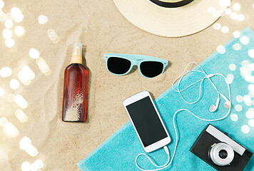 Image showing smartphone, camera, towel, hat and shades on beach