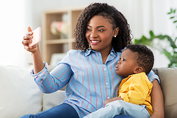 Image showing african mother with baby son taking selfie at home