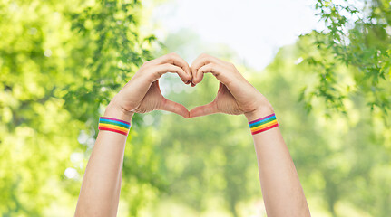 Image showing male hands with gay pride wristbands showing heart