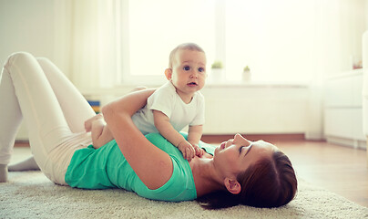 Image showing happy mother playing with baby at home