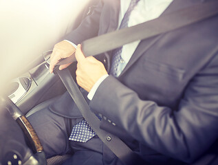 Image showing senior businessman fastening car seat belt