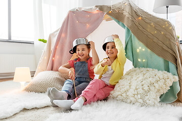 Image showing girls with pots playing in kids tent at home