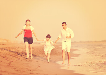 Image showing happy young family have fun on beach