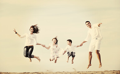 Image showing happy young family have fun on beach