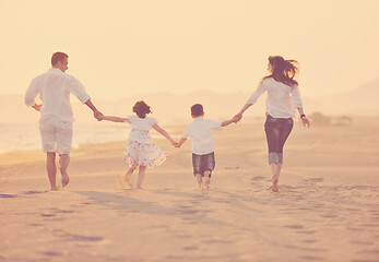 Image showing happy young family have fun on beach at sunset