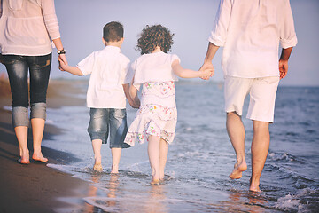 Image showing happy young family have fun on beach at sunset