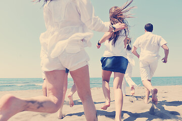 Image showing happy people group have fun and running on beach