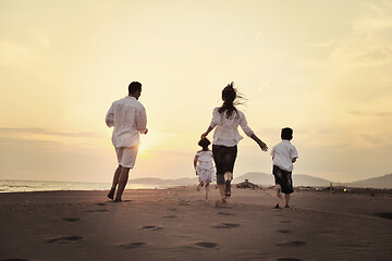 Image showing happy young family have fun on beach at sunset