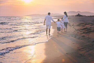 Image showing happy young family have fun on beach at sunset