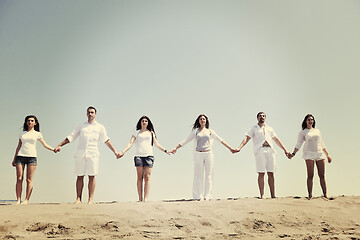 Image showing happy people group have fun and running on beach