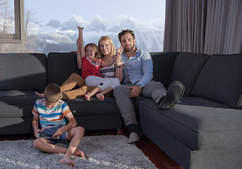 Image showing happy young couple spending time with kids at home