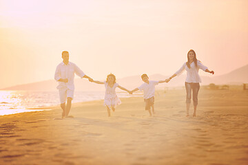 Image showing happy young family have fun on beach at sunset