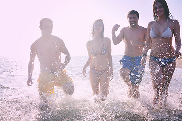 Image showing happy people group have fun and running on beach