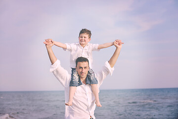 Image showing happy father and son have fun and enjoy time on beach