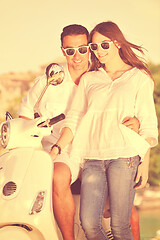 Image showing Portrait of happy young love couple on scooter enjoying summer t