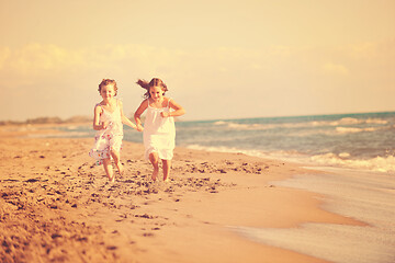 Image showing cute little girls running on beach