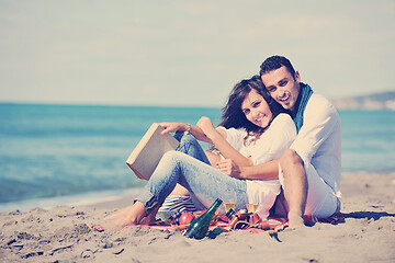 Image showing young couple enjoying  picnic on the beach