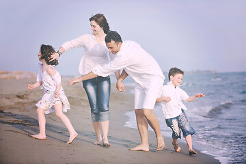 Image showing happy young family have fun on beach