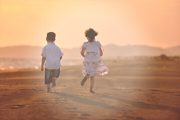 Image showing happy young family have fun on beach at sunset