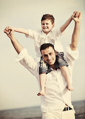 Image showing happy father and son have fun and enjoy time on beach