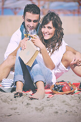 Image showing young couple enjoying  picnic on the beach