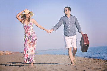 Image showing couple on beach with travel bag