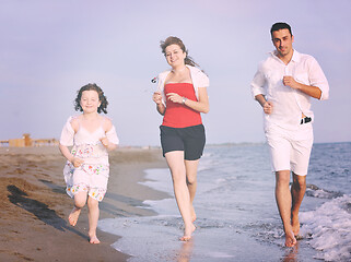 Image showing happy young family have fun on beach