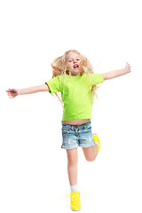 Image showing Full length portrait of cute little kid in stylish jeans clothes looking at camera and smiling