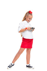 Image showing Full length portrait of cute little kid in stylish clothes with retro camera