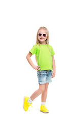 Image showing Full length portrait of cute little kid in stylish jeans clothes looking at camera and smiling