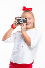 Image showing Full length portrait of cute little kid in stylish clothes with retro camera