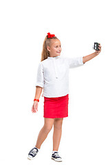 Image showing Full length portrait of cute little kid in stylish clothes with retro camera
