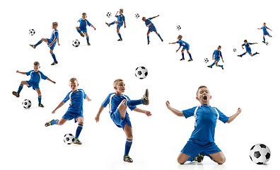 Image showing Young boy with soccer ball doing flying kick