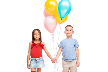 Image showing Full length portrait of cute little kids in stylish clothes looking at camera and smiling