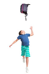 Image showing Full length portrait of cute little kid in stylish clothes jumping with bag