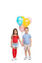 Image showing Full length portrait of cute little kids in stylish clothes looking at camera and smiling