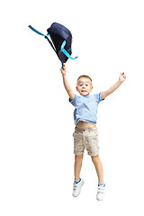 Image showing Full length portrait of cute little kid in stylish clothes jumping with bag