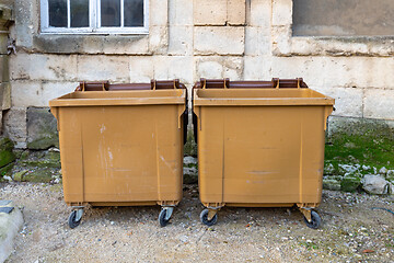 Image showing Two Brown Dumpsters